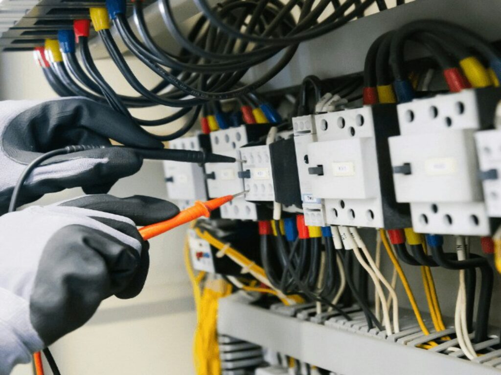 Image of electrician working on contactors.
